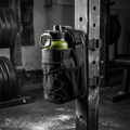 Magnetic bottle bag stuck to a squat rack in a gym