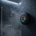 Suction shower speaker lit up on wet shower tiles