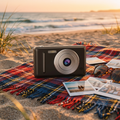 Retro digital camera on a beach picnic blanket at golden hour