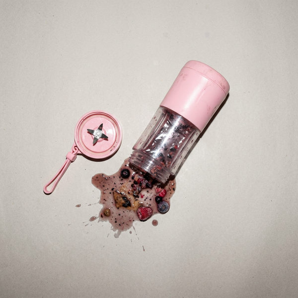 Mini blender with unblended smoothie spilled